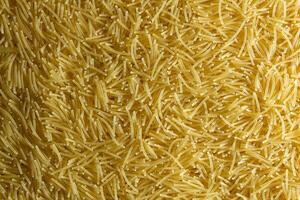 Uncooked Filini Pasta. A Culinary Canvas of Noodles, Creating a Lively and Textured Background for Gourmet Cooking. Dry Pasta. Raw Macaroni - Top View, Flat Lay photo