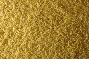 Uncooked Filini Pasta. A Culinary Canvas of Noodles, Creating a Lively and Textured Background for Gourmet Cooking. Dry Pasta. Raw Macaroni - Top View, Flat Lay photo