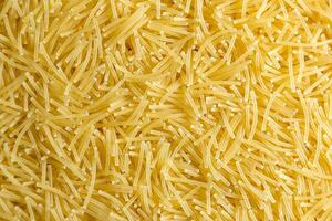 Uncooked Filini Pasta. A Culinary Canvas of Noodles, Creating a Lively and Textured Background for Gourmet Cooking. Dry Pasta. Raw Macaroni - Top View, Flat Lay photo