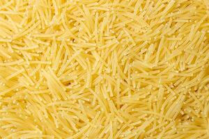 Uncooked Filini Pasta. A Culinary Canvas of Noodles, Creating a Lively and Textured Background for Gourmet Cooking. Dry Pasta. Raw Macaroni - Top View, Flat Lay photo