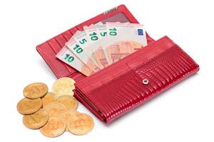 Opened Red Women Purse with 10 Euro Banknotes Inside and Bitcoin Coins - Isolated on White Background. A Wallet Full of Money Symbolizing Wealth, Success, Shopping and Social Status - Isolation photo