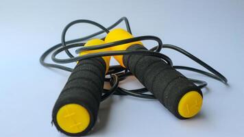 Skipping rope on a white background. Skipping rope is a useful exercise tool for cardio training. For those who are increasing strength and losing weight. photo