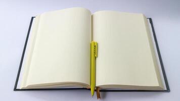 White plain diary or blank journal for writing memo, note and message. Sketchbook or booklet with open page for business, studying, or learning. Notebook mock up design concept for office or lifestyle photo