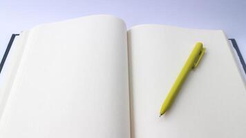 White plain diary or blank journal for writing memo, note and message. Sketchbook or booklet with open page for business, studying, or learning. Notebook mock up design concept for office or lifestyle photo