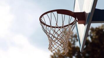 Basketball hoop with net against clear sky, showcasing sports essence and outdoor playfulness. Perfect for sports enthusiasts and basketball lovers photo