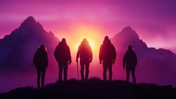 group of five hikers stands silhouetted against vibrant sunset, surrounded by majestic mountains. scene captures sense of adventure and camaraderie in natures beauty photo