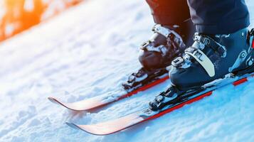 Ski boots and skis positioned on snowy slope, showcasing thrill of winter sports. vibrant colors of sunset enhance excitement of skiing photo