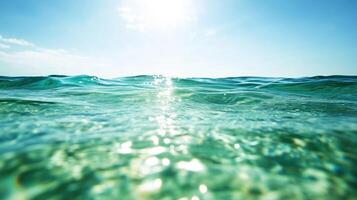 serene ocean waves glisten under bright sun, creating tranquil and refreshing atmosphere. clear water reflects light beautifully, inviting relaxation and peace photo