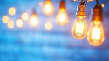 Bright and warm glowing light bulbs create cozy atmosphere against soft blue background, perfect for enhancing any space with touch of charm and elegance photo
