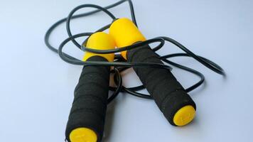 Skipping rope on a white background. Skipping rope is a useful exercise tool for cardio training. For those who are increasing strength and losing weight. photo