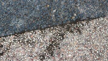 Exposed aggregate concrete with different colored pebbles. Gravel floor in city park. photo