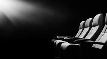 row of empty cinema seats illuminated by beam of light, creating dramatic atmosphere. scene evokes sense of anticipation and solitude photo