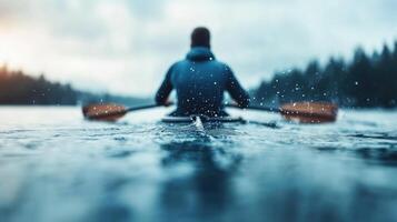 person is kayaking on serene lake, creating splashes as they paddle through calm water. scene captures beauty of nature and tranquility of outdoor activities photo