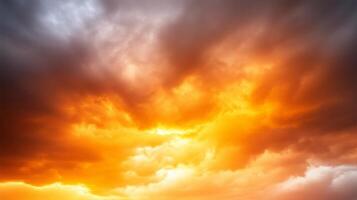 Breathtaking sunset clouds display vibrant hues of orange and gray, creating dramatic sky filled with swirling patterns and textures. scene evokes sense of wonder and tranquility photo