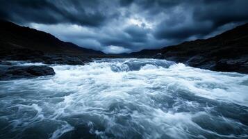 dramatic scene of turbulent waters rushing through rocky terrain under moody sky. powerful waves create sense of energy and movement, capturing raw beauty of nature photo