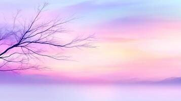 serene landscape featuring delicate tree branch silhouetted against dreamy pastel sky. soft hues of pink, purple, and blue create tranquil atmosphere, perfect for relaxation and reflection photo
