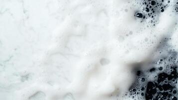 close up view of white and black foam on marble surface creates striking contrast, evoking sense of cleanliness and freshness. bubbles add texture and depth to image photo