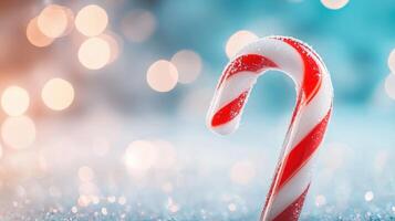 festive candy cane stands prominently against blurred background of soft, colorful bokeh lights, evoking joyful holiday spirit. sugary texture glistens, enhancing seasonal charm photo