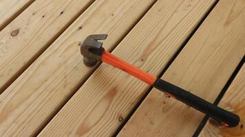 Home construction background. Hammer on wooden table flat lay. photo