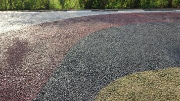 Black asphalt. Pebble stone flooring with epoxy resin in city park. Pebble stone is yellow and red. photo