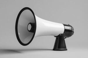 White and Black Handheld Megaphone with a Grey Background photo