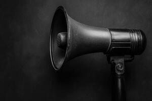 Black Megaphone with a Microphone on a Dark Background photo