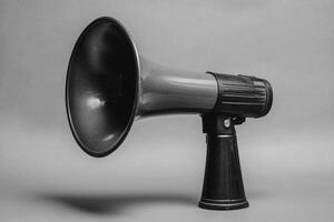 Black Handheld Megaphone on a Gray Background photo
