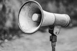 A Worn Vintage Megaphone Mounted on a Stand photo