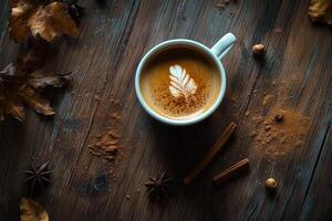 A Cup of Latte with Cinnamon and Autumn Accents on a Rustic Wooden Table photo