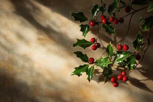 Sprig of Holly with Red Berries on a Tan Background photo