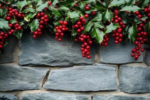Red Berries and Green Leaves Hanging Over a Stone Wall photo