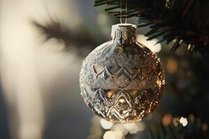 A Single Silver Christmas Ornament Hanging on a Tree photo