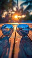 Close-up of stylish blue reflective sunglasses on wooden table at sunset, capturing summer vibes photo