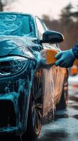 Car being washed with foam soap close-up, highlighting luxury vehicle cleanliness and thoroughness photo