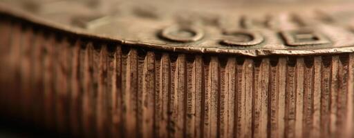 Close-up of coin edge. serrations and detailed texture pattern of golden coins in macro view photo