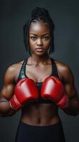 Confident female boxer with red gloves in strong stance, showing power, fitness, and determination photo