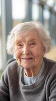 Smiling elderly woman in hospital reception close-up portrait in modern bright hallway photo