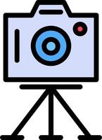A camera on a tripod with a blue light vector