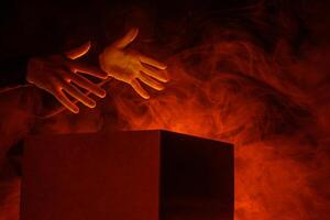 Man opens magic box with surprise on dark background, mystical box, surprise, halloween photo