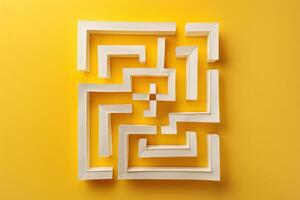A white maze made out of paper on a yellow background photo