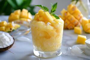 A glass of pineapple juice with a spoon photo