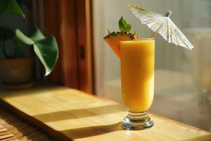 A drink with a pineapple and umbrella sitting on a table photo