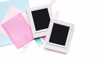 Pink and blue paper with a blank photo frame