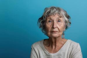 An older woman with gray hair and a sad expression photo