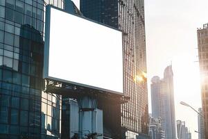 An empty billboard in front of tall buildings photo