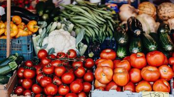 A variety of vegetables are displayed at a market photo