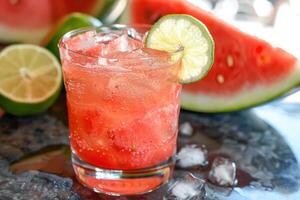A watermelon and lime cocktail with a slice of lime photo