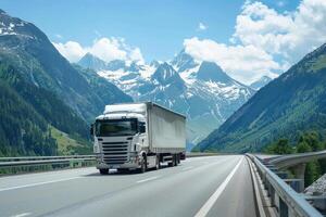 A truck driving on a highway in front of mountains photo