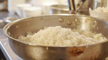 A large metal bowl filled with rice photo