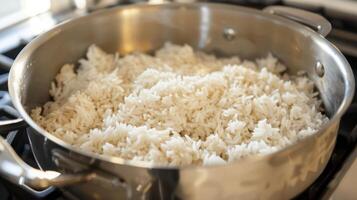 A pot filled with white rice on the stove photo